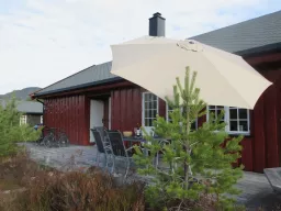 Terrasse med parasoll ved hytta